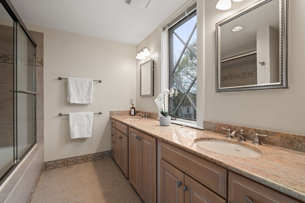 53 Winslow Road Brookline, MA 02446 - Photo 15 of 23 a bathroom with a granite countertop sink and a mirror