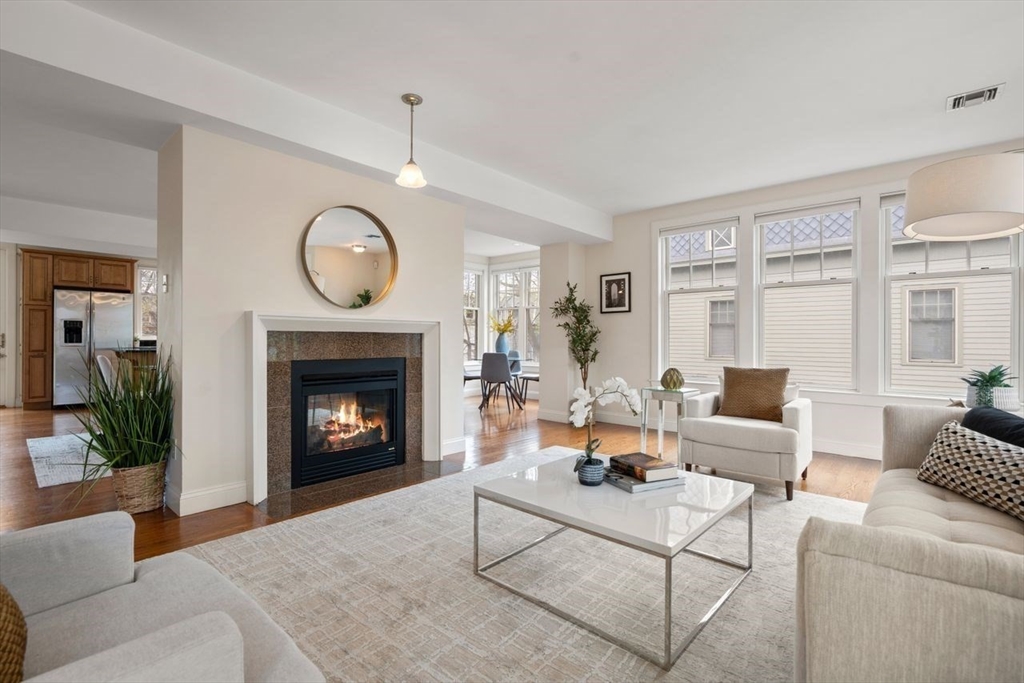 53 Winslow Road Brookline, MA 02446 - Photo 2 of 23 a living room with furniture a fireplace and a large window