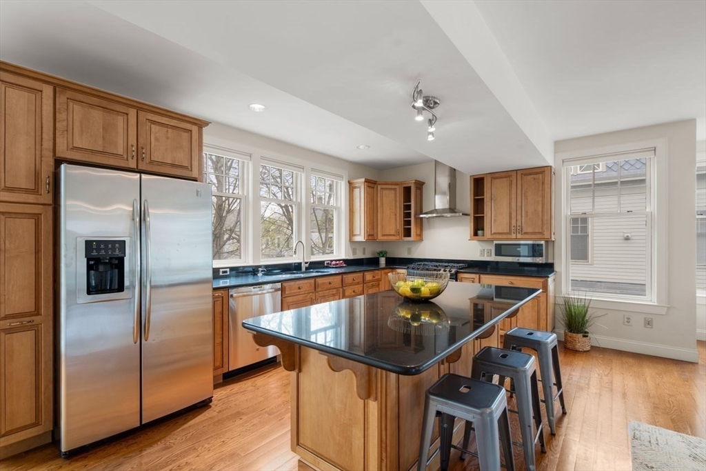 53 Winslow Road Brookline, MA 02446 - Photo 4 of 23 a kitchen with stainless steel appliances granite countertop a sink a stove and a refrigerator
