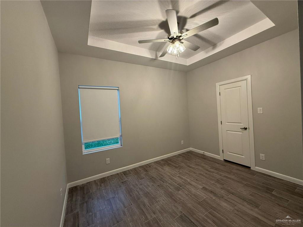 809 Dove Avenue, Unit 4 Edinburg, TX 78542 - Photo 12 of 19 wooden floor in an empty room with a window