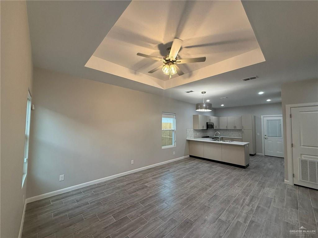 809 Dove Avenue, Unit 4 Edinburg, TX 78542 - Photo 3 of 19 a living room with stainless steel appliances furniture and a chandelier