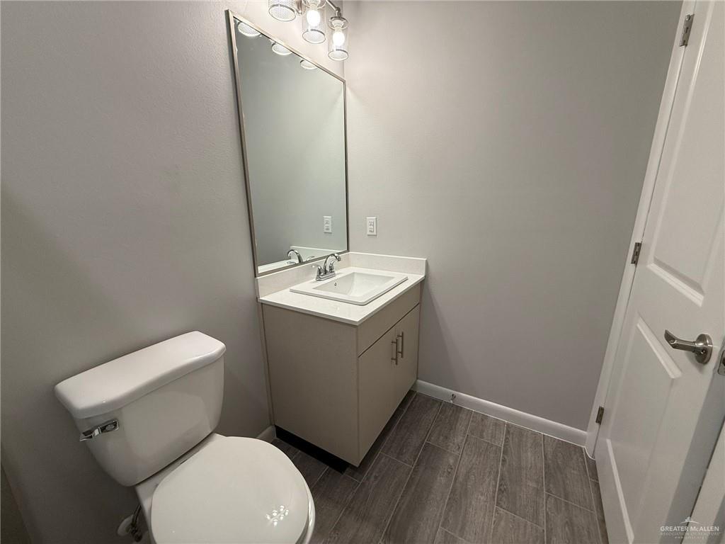 809 Dove Avenue, Unit 4 Edinburg, TX 78542 - Photo 10 of 19 a bathroom with a toilet sink and mirror