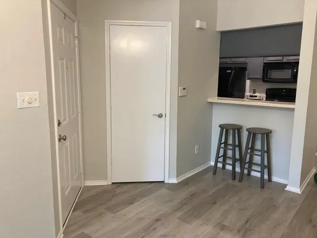 a view of a kitchen with a sink wooden floor and a kitchen