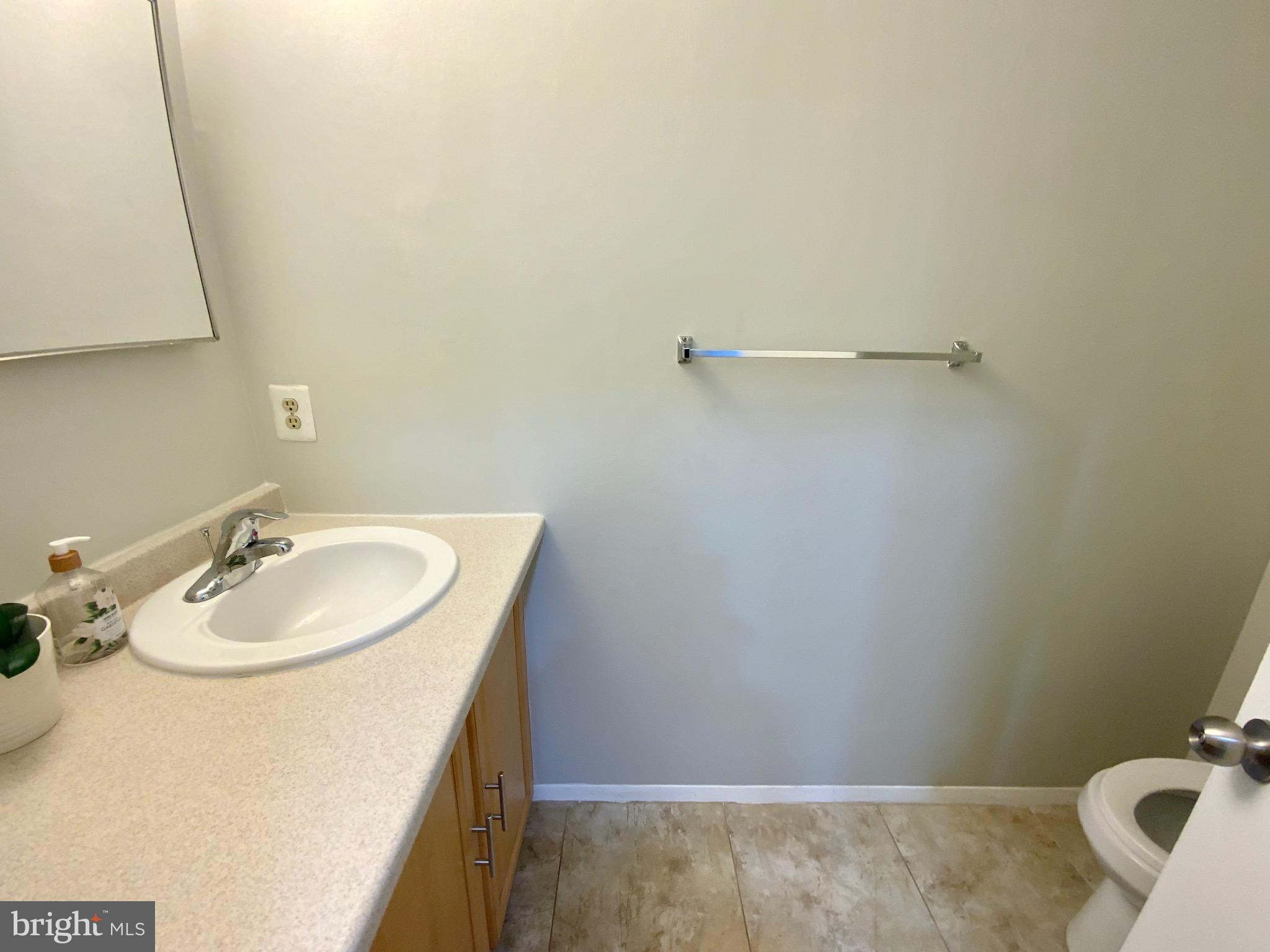 1824 Bronzegate Boulevard, Unit 182 Silver Spring, MD 20904 - Photo 11 of 14 a bathroom with a sink and a mirror