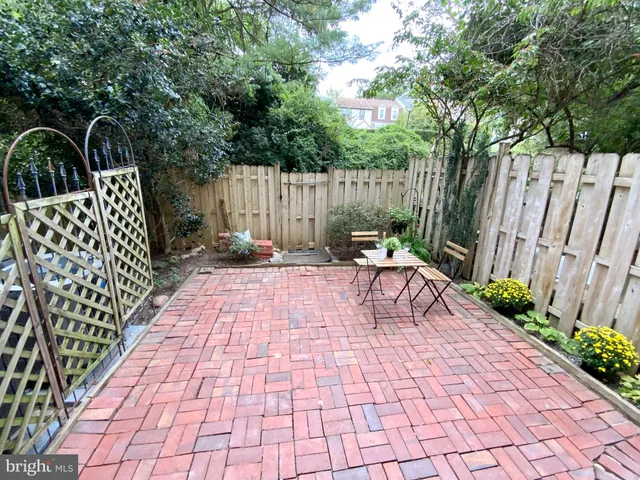 a view of backyard with sitting area