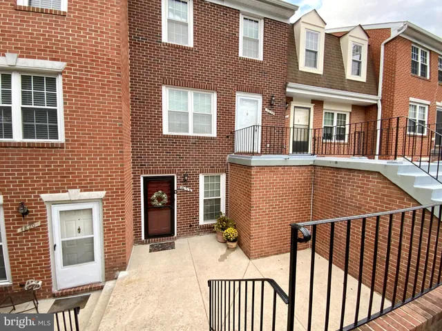 a view of a brick house with many windows