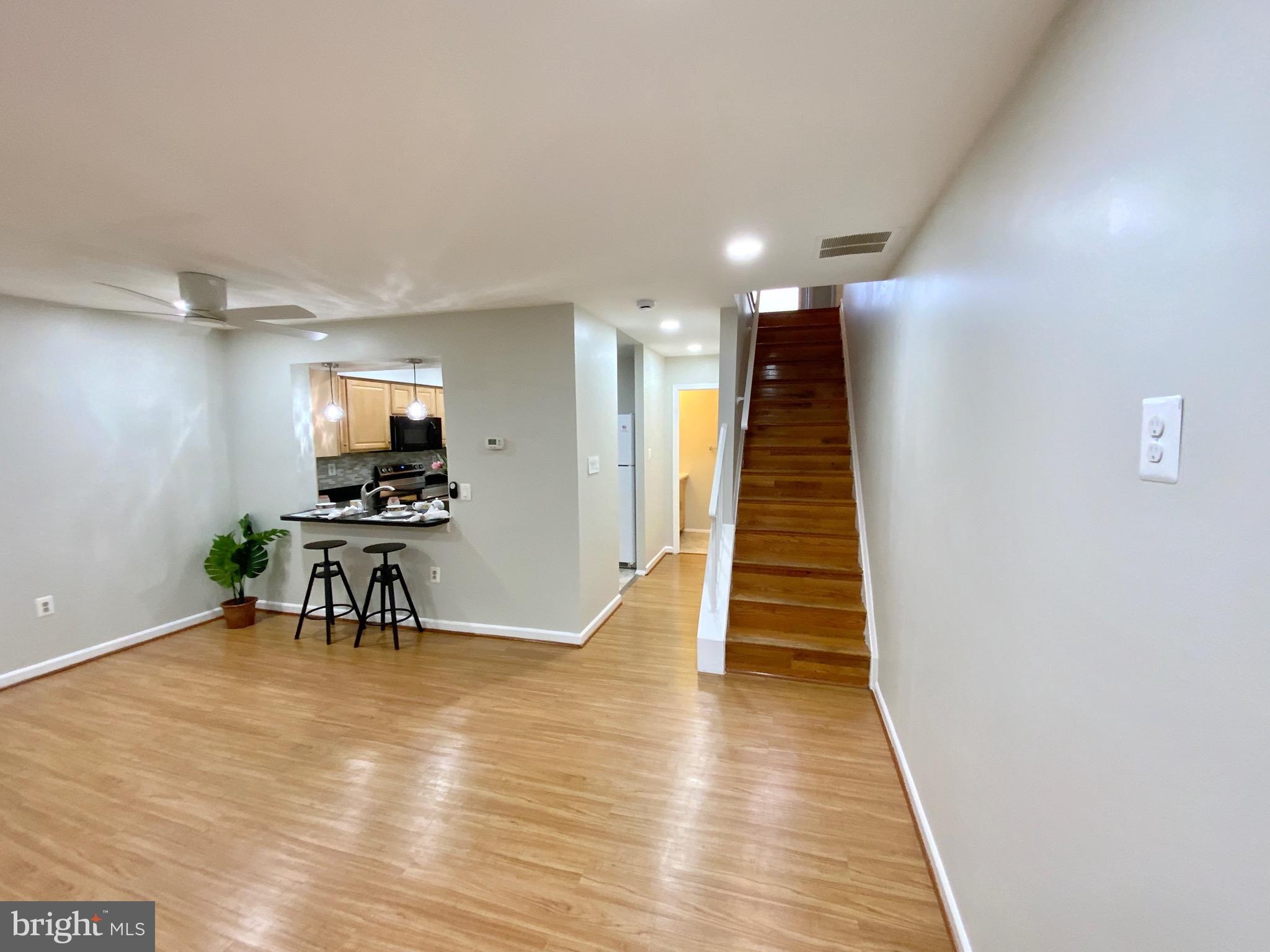 1824 Bronzegate Boulevard, Unit 182 Silver Spring, MD 20904 - Photo 8 of 14 a dining room with furniture and wooden floor