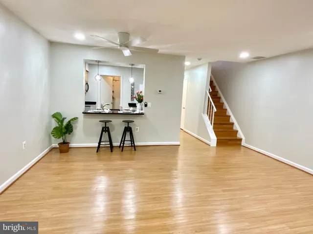 a view of a room with wooden floor and potted plants