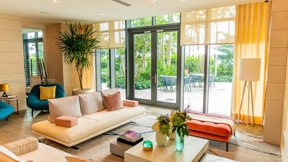 650 Northeast 32nd Street, Unit 2105 Miami, FL 33137 - Photo 36 of 61 a living room with furniture and floor to ceiling windows