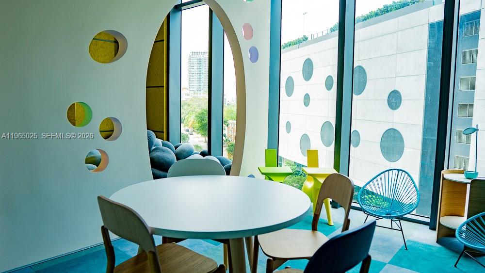 650 Northeast 32nd Street, Unit 2105 Miami, FL 33137 - Photo 44 of 61 a view of a dining room with furniture and wooden floor
