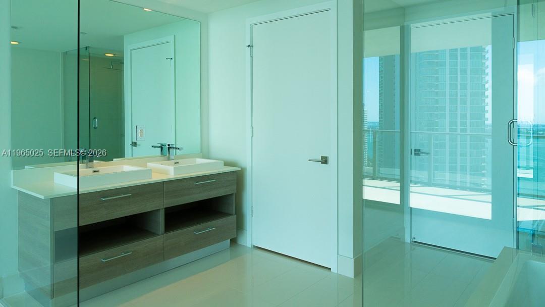 650 Northeast 32nd Street, Unit 2105 Miami, FL 33137 - Photo 9 of 61 a bathroom with a sink and a mirror