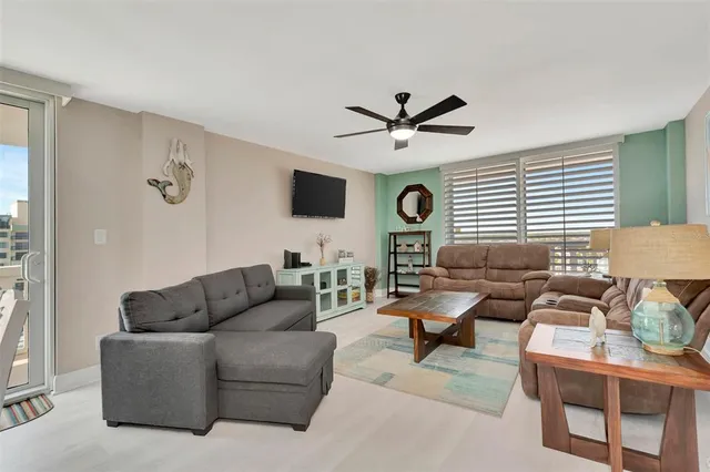 a living room with furniture a view of bedroom and a couch