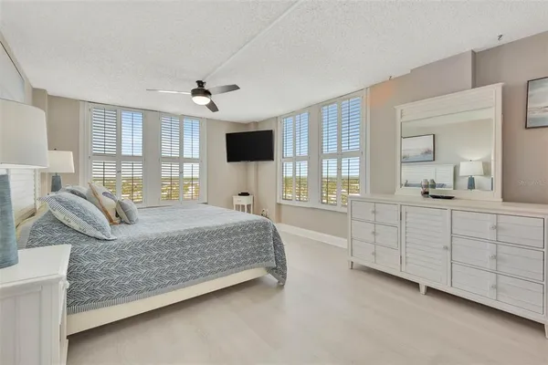 a bedroom with a large bed and a chandelier