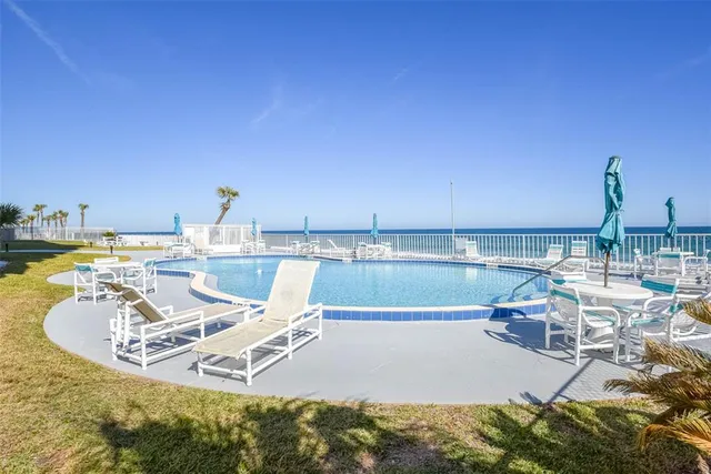 a view of a swimming pool with an ocean view
