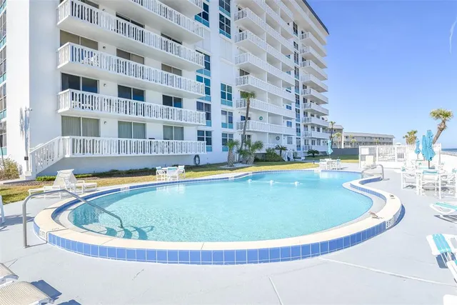 a view of swimming pool with outdoor seating and city view