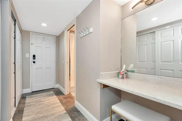 a bathroom with a toilet sink vanity and mirror