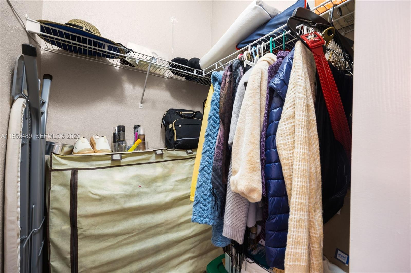 3985 Northeast 15th Street Homestead, FL 33033 - Photo 30 of 67 a close view of walk in closet with clothes and shoes