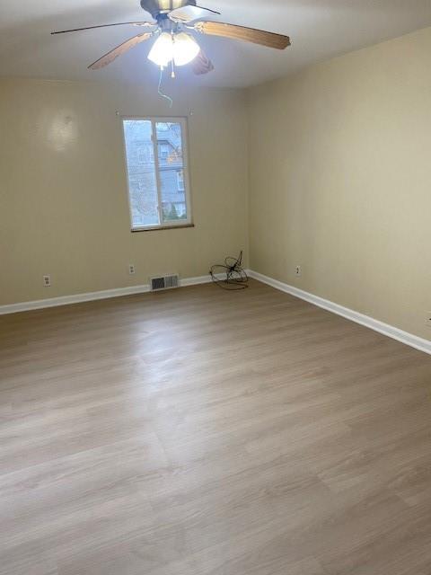 7025 Meade Street, Unit 1 Pittsburgh, PA 15208 - Photo 13 of 21 an empty room with a chandelier fan and windows