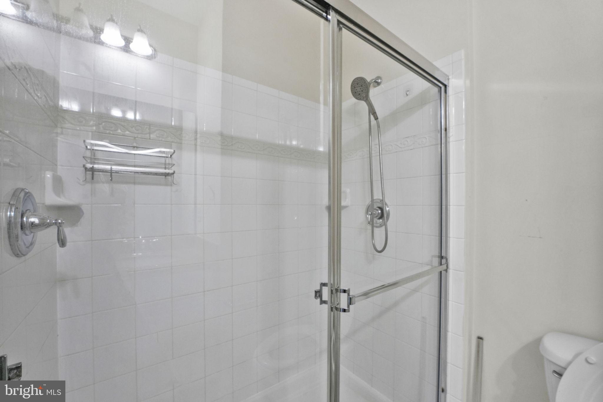 7138 Station House Road Elkridge, MD 21075 - Photo 17 of 42 a bathroom with a glass shower door