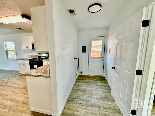 Undisclosed Address Bakersfield, CA 93308 - Photo 7 of 16 a view of a kitchen from the hallway