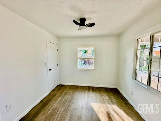 Undisclosed Address Bakersfield, CA 93308 - Photo 8 of 16 an empty room with wooden floor and windows