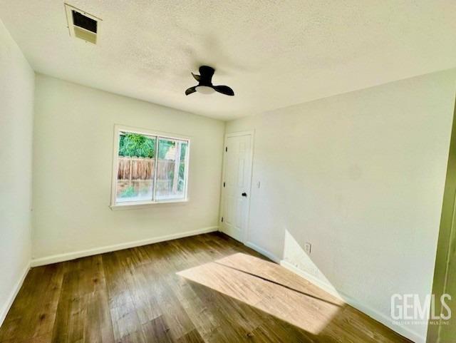 Undisclosed Address Bakersfield, CA 93308 - Photo 9 of 16 a view of a room with wooden floor and cabinet