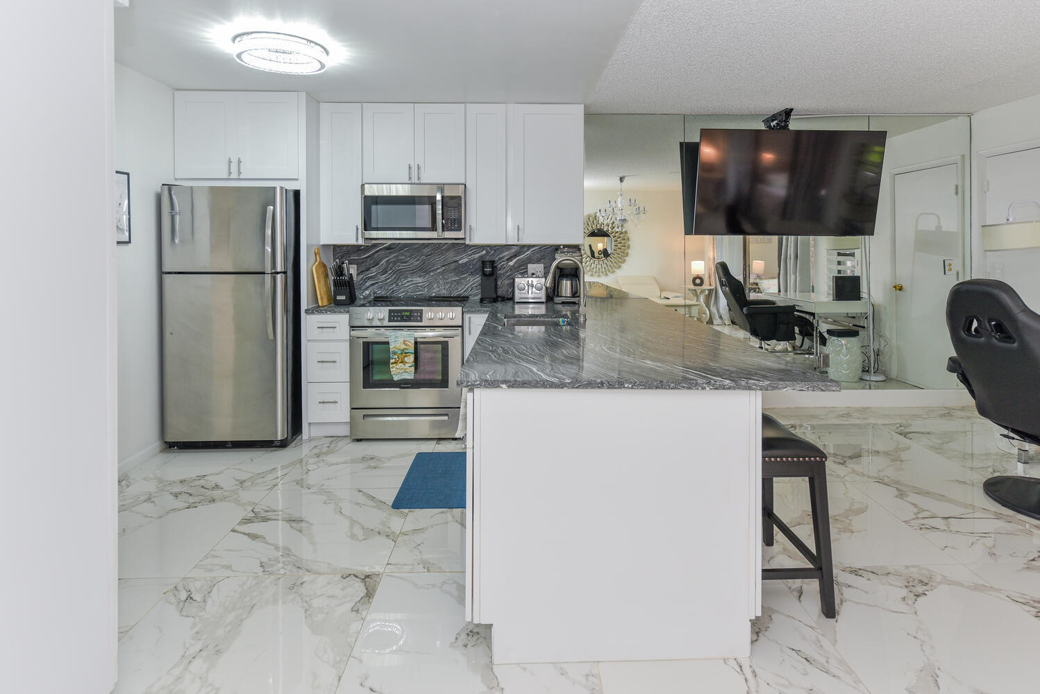 1605 Highway 1, Unit V4206 Jupiter, FL 33477 - Photo 1 of 30 a kitchen with a refrigerator a microwave a sink and cabinets