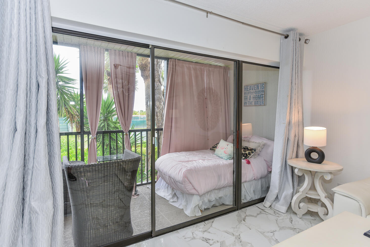 1605 Highway 1, Unit V4206 Jupiter, FL 33477 - Photo 16 of 30 a bedroom with a bed and a mirror