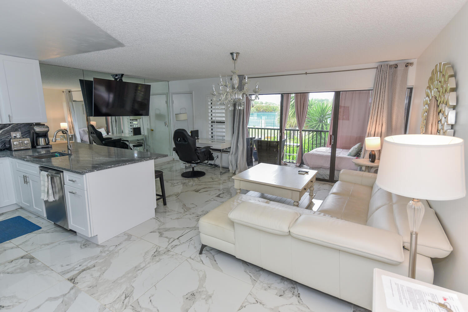 1605 Highway 1, Unit V4206 Jupiter, FL 33477 - Photo 5 of 30 a living room with furniture a flat screen tv and a large window