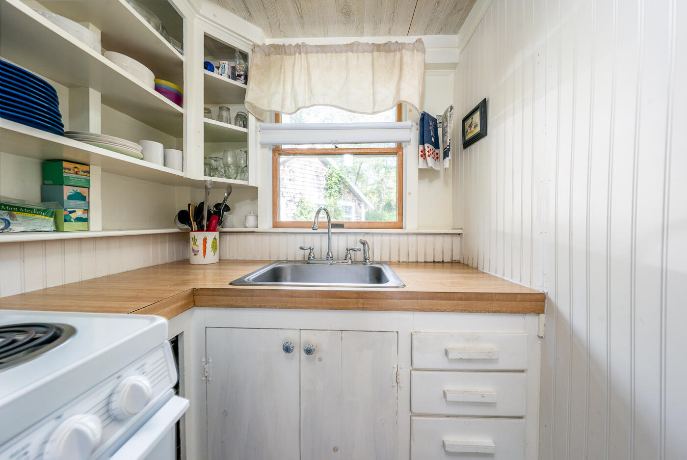 215 Pilgrim Spring Road, Unit G Wellfleet, MA 02667 - Photo 14 of 32 a kitchen with a sink cabinets and a window