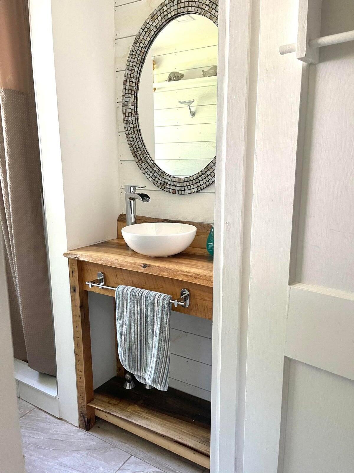 215 Pilgrim Spring Road, Unit G Wellfleet, MA 02667 - Photo 20 of 32 a bathroom with a sink and a mirror