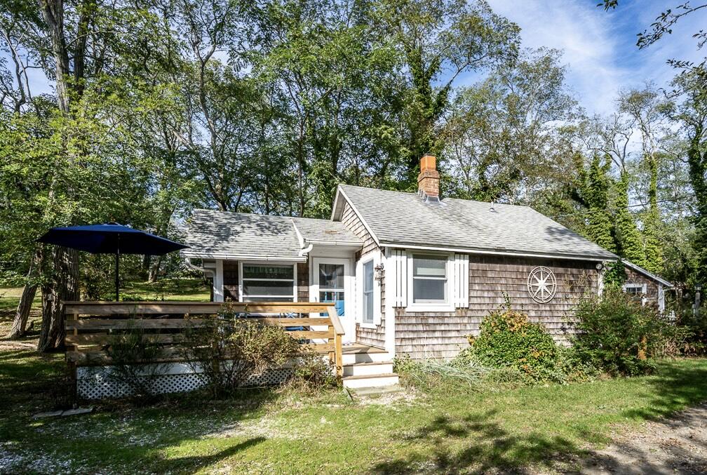 215 Pilgrim Spring Road, Unit G Wellfleet, MA 02667 - Photo 2 of 32 a front view of a house with a yard