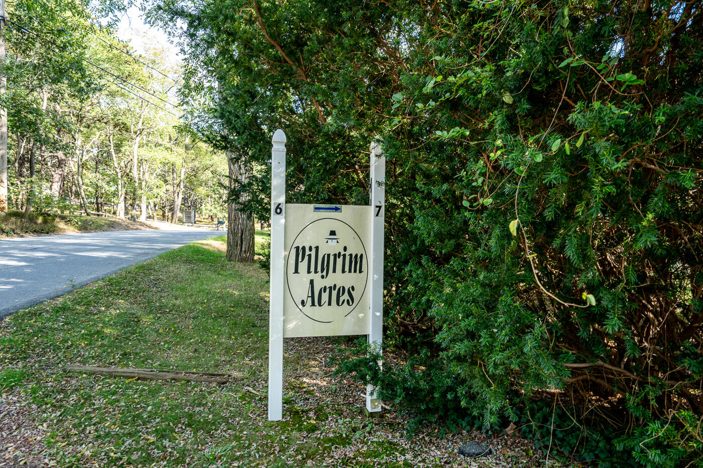 215 Pilgrim Spring Road, Unit G Wellfleet, MA 02667 - Photo 31 of 32 a sign that is sitting in the grass