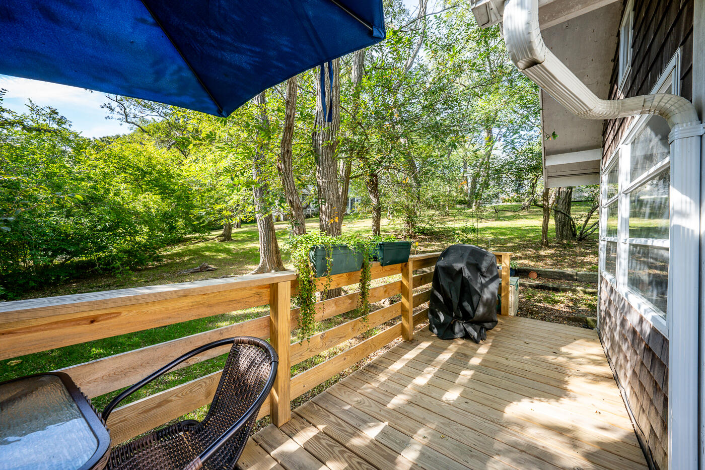 215 Pilgrim Spring Road, Unit G Wellfleet, MA 02667 - Photo 5 of 32 a view of a chairs and table in the patio