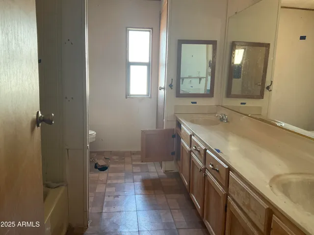 a bathroom with a sink a vanity and a mirror