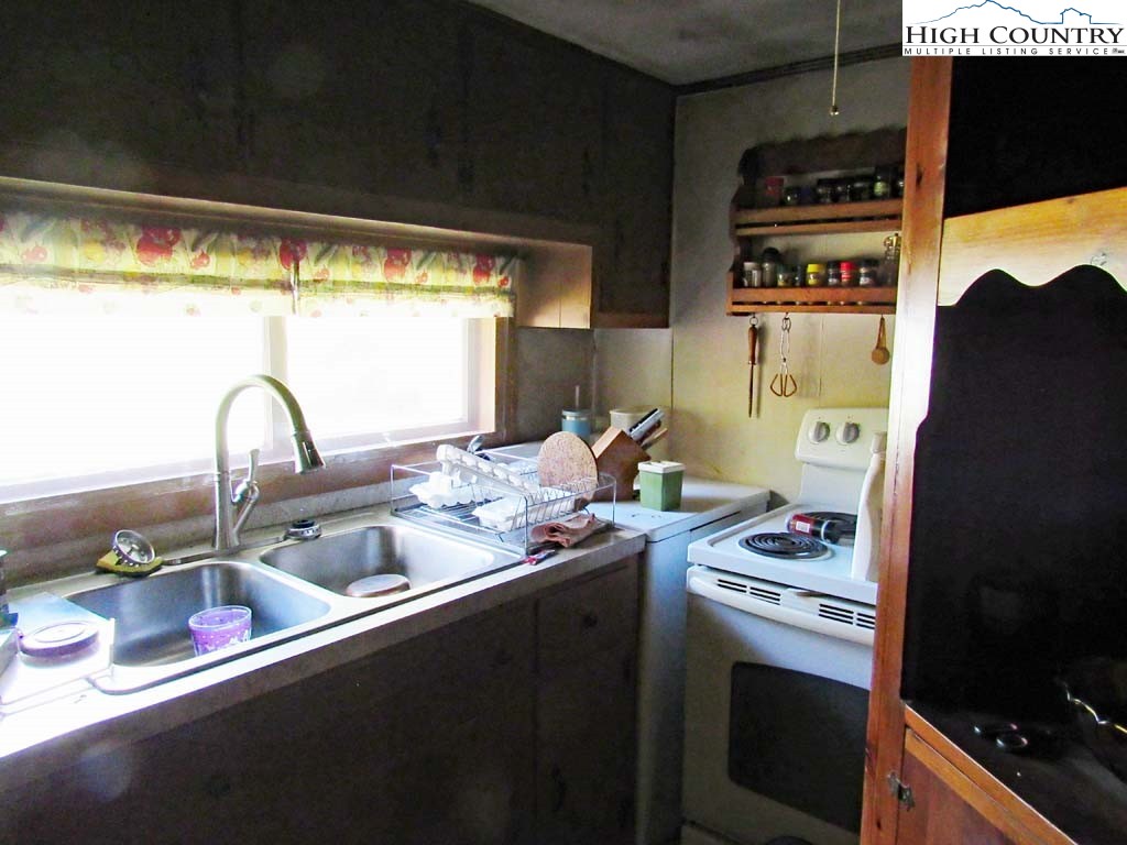458 Paul Goodman Road Fleetwood, NC 28626 - Photo 20 of 22 a kitchen with stainless steel appliances a stove and a refrigerator
