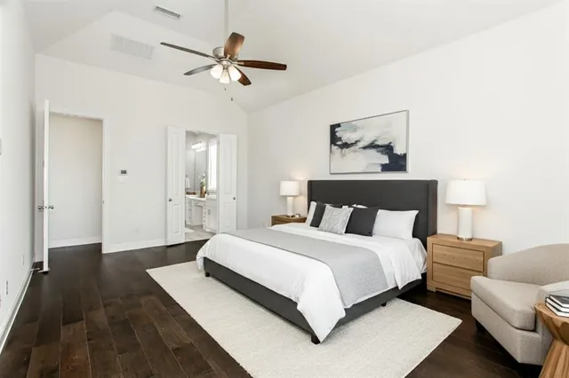 a spacious bedroom with a bed and a ceiling fan