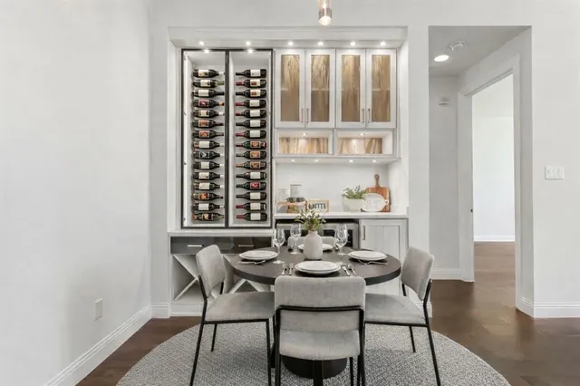 a dining room with furniture a chandelier and wooden floor