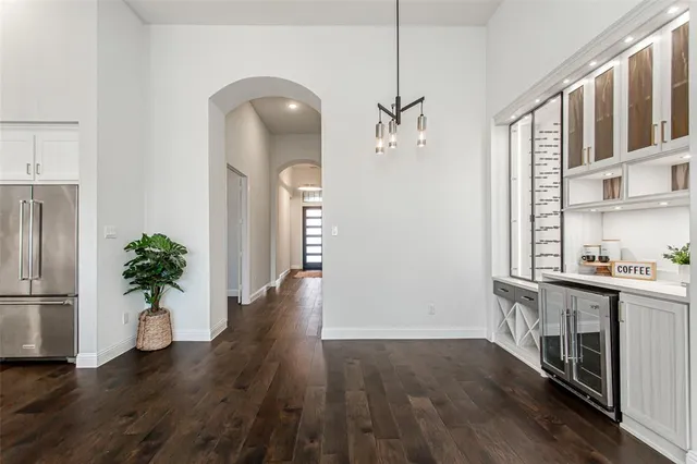 a large kitchen with cabinets wooden floor and stainless steel appliances