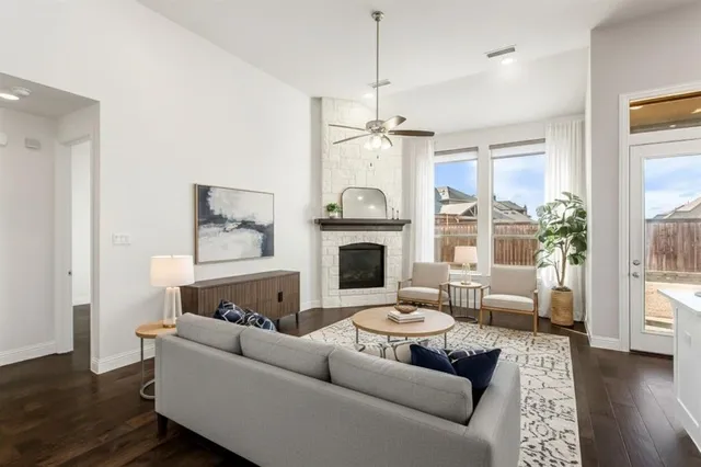 a living room with fireplace furniture and a wooden floor