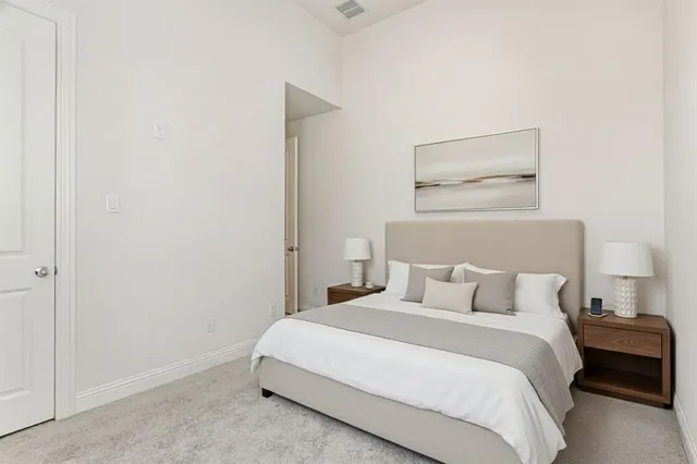 a bedroom with a bed and a night stand