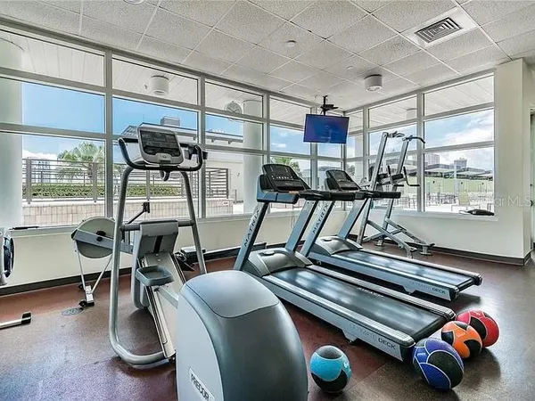 a room with gym equipment and windows