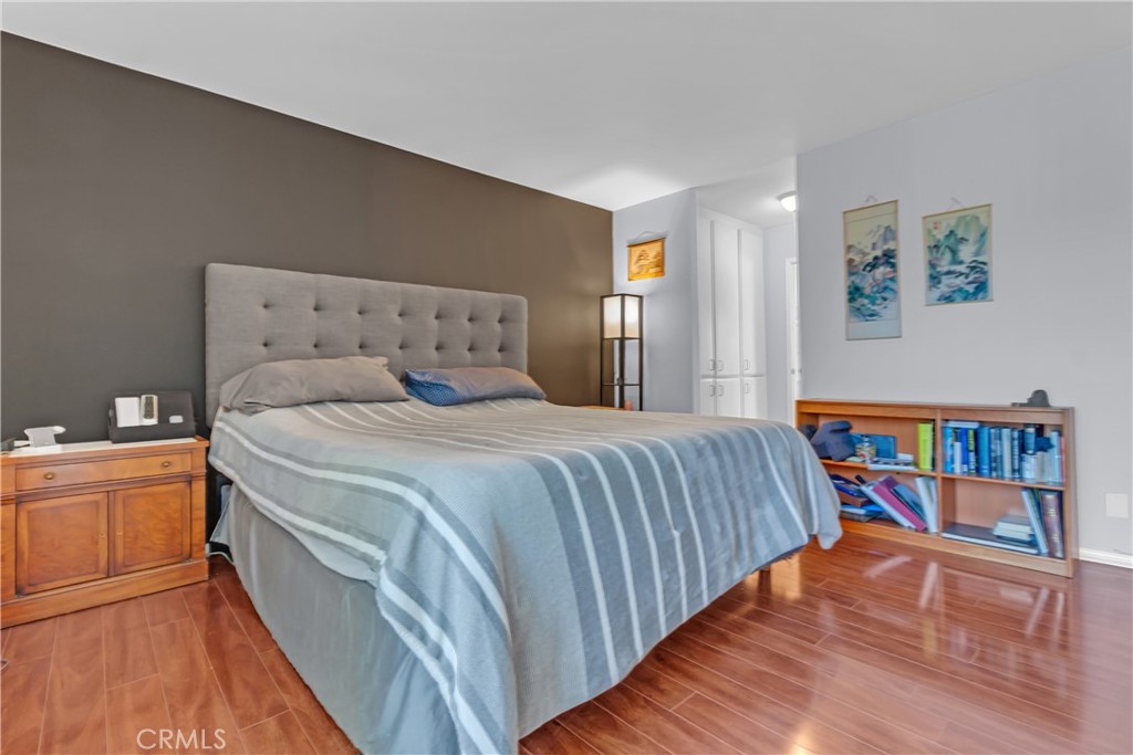 12334 Chandler Boulevard, Unit C Valley Village, CA 91607 - Photo 14 of 30 a bedroom with a bed and a book shelf