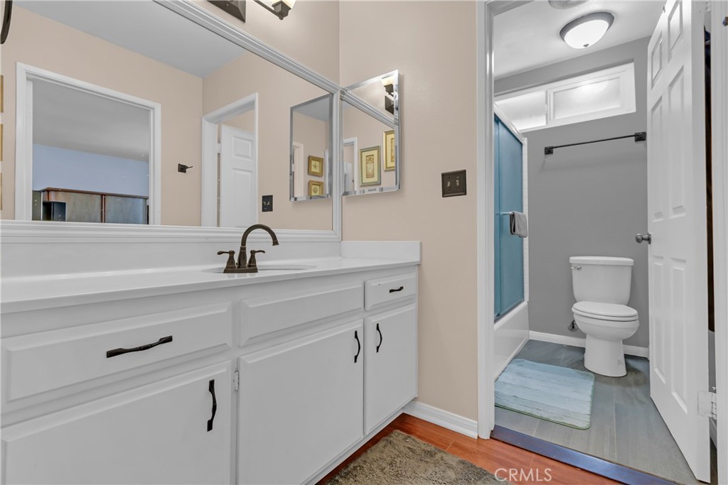 12334 Chandler Boulevard, Unit C Valley Village, CA 91607 - Photo 18 of 30 a bathroom with a sink a toilet and a mirror