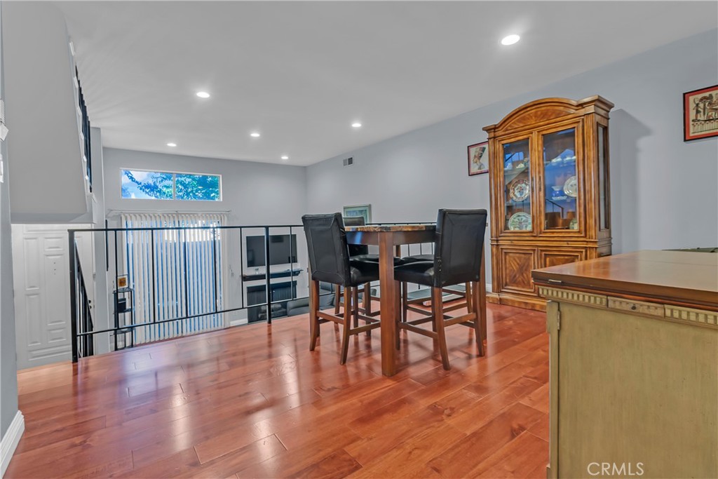 12334 Chandler Boulevard, Unit C Valley Village, CA 91607 - Photo 9 of 30 a view of a dining room with furniture and wooden floor