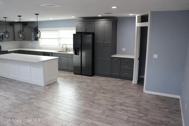 a kitchen with stainless steel appliances a refrigerator and a sink