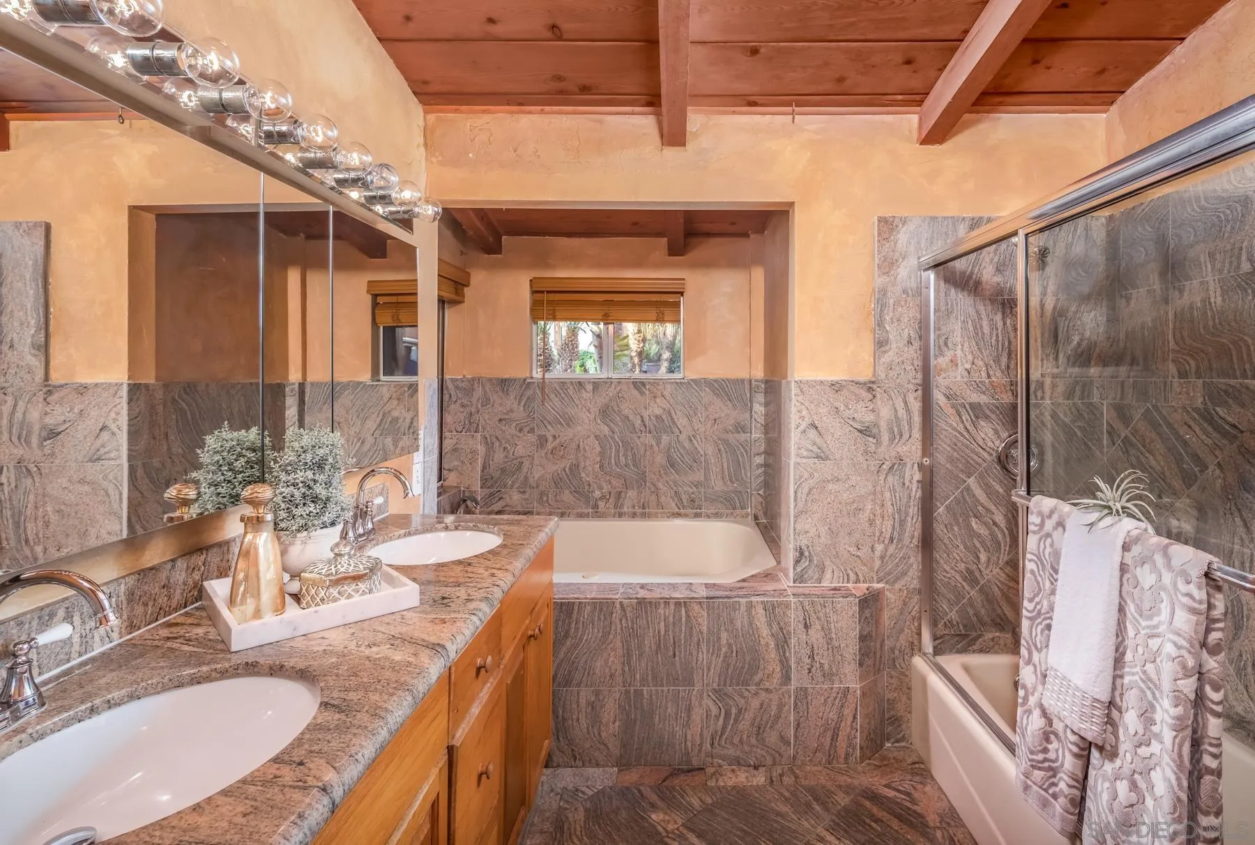 110 8th Street Del Mar, CA 92014 - Photo 14 of 24 a bathroom with a granite countertop bathtub sink vanity and mirror