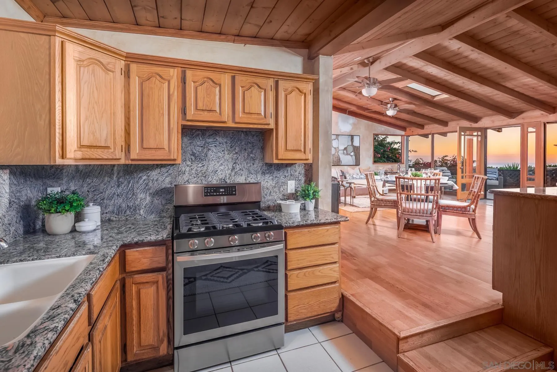 110 8th Street Del Mar, CA 92014 - Photo 9 of 24 a kitchen with stainless steel appliances granite countertop a stove a sink dishwasher and cabinets with wooden floor