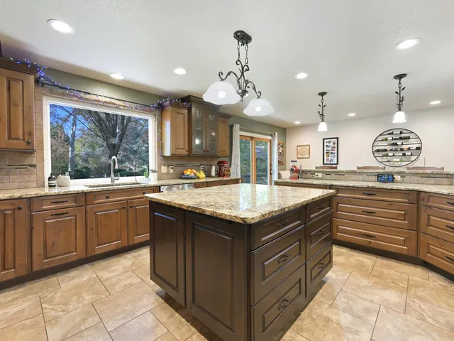 a kitchen with stainless steel appliances granite countertop a stove and cabinets
