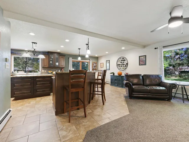 a bathroom with a granite countertop toilet sink and mirror